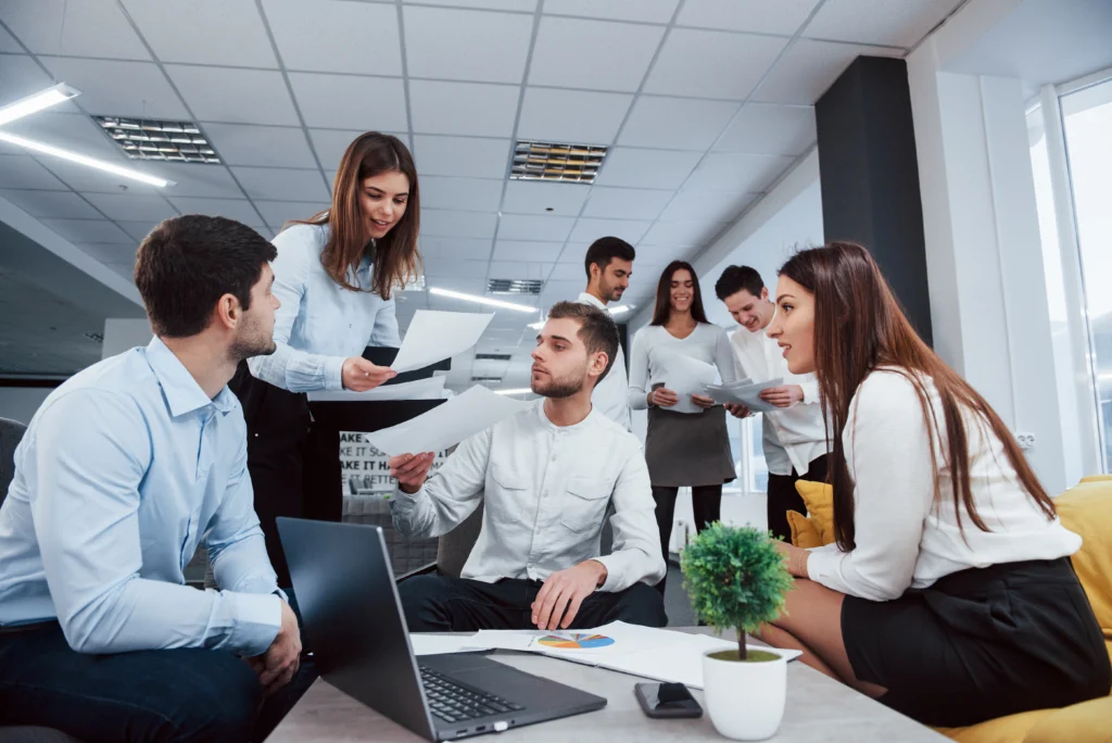 working fun atmosphere group young freelancers office have conversation smiling